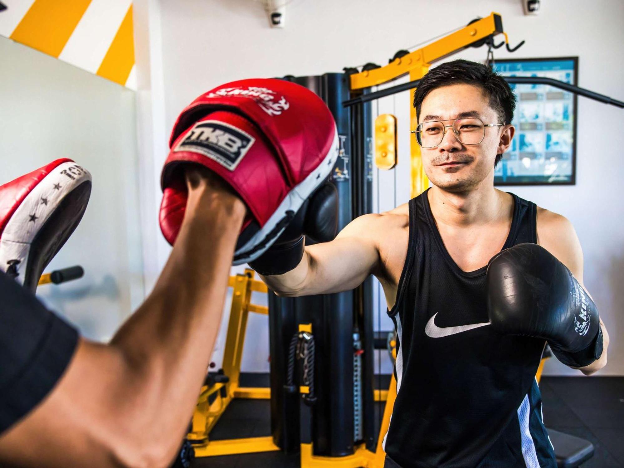 Grand Mercure Phuket Patong Esterno foto A boxer training with a heavy bag